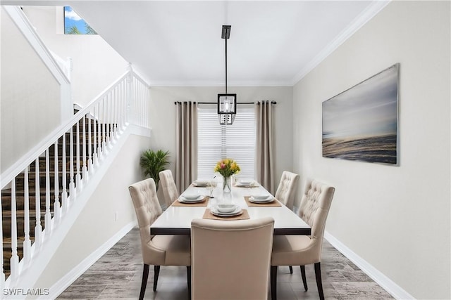 dining room featuring wood-type flooring and ornamental molding