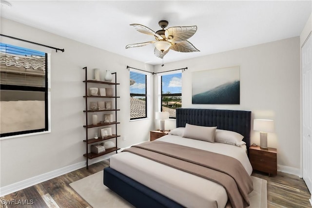 bedroom with dark hardwood / wood-style flooring and ceiling fan