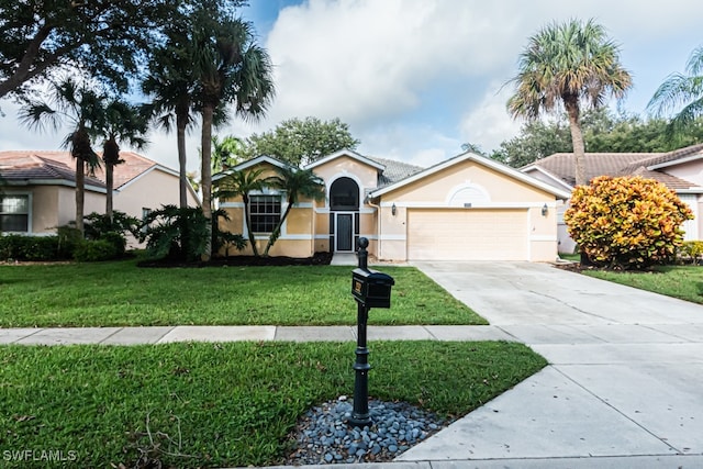 single story home with a front yard and a garage