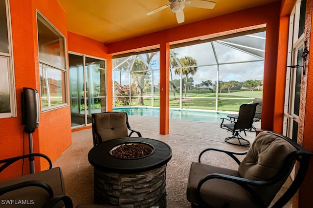 sunroom featuring a pool and ceiling fan