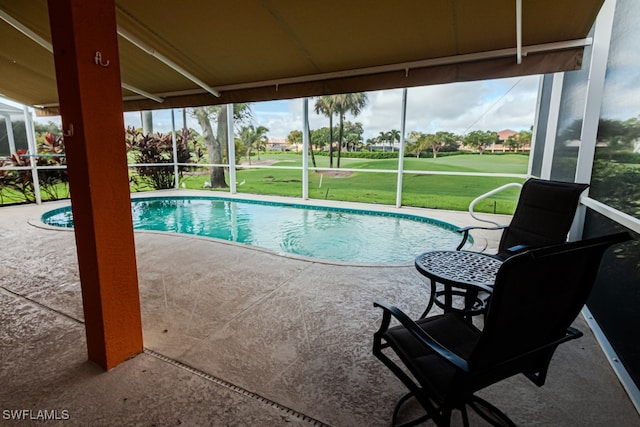 view of pool featuring a patio, a lawn, and glass enclosure