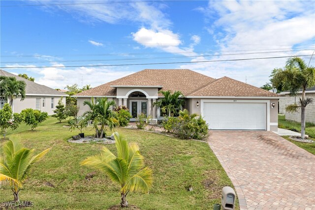 view of front of property featuring a garage and a front lawn