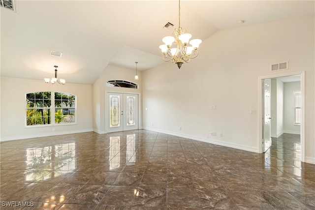 spare room featuring french doors, high vaulted ceiling, and a chandelier