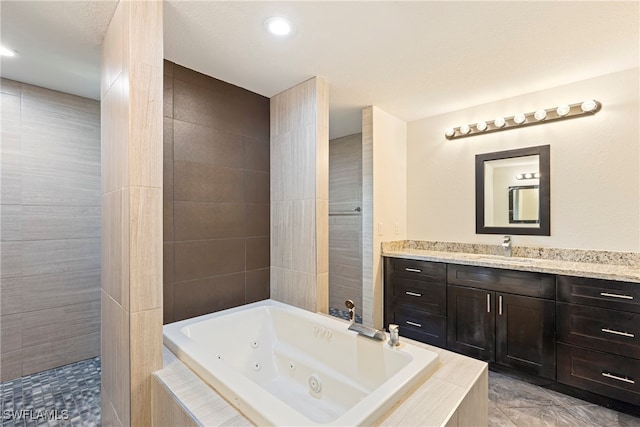 bathroom featuring plus walk in shower and vanity