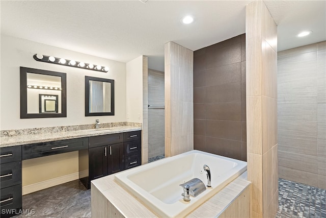 bathroom featuring vanity and a relaxing tiled tub