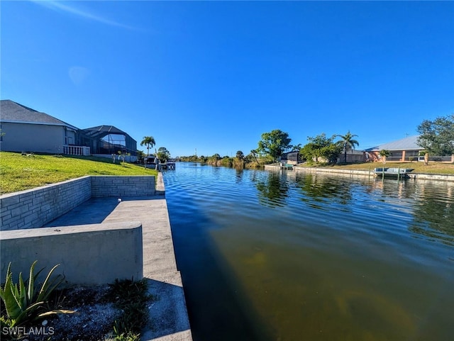 dock area featuring a yard and a water view