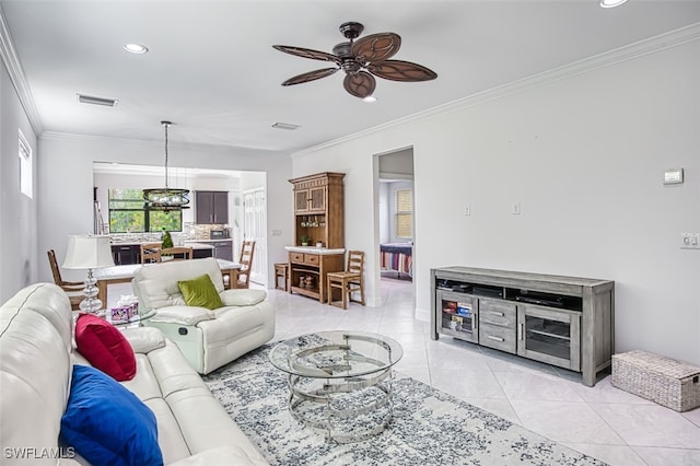 living room with light tile patterned floors, ceiling fan, and ornamental molding