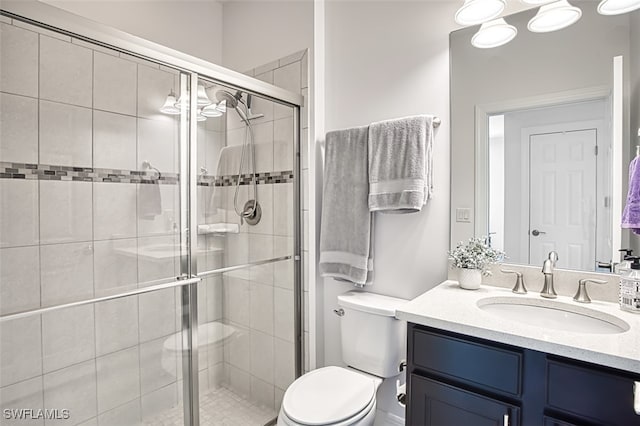 bathroom with vanity, toilet, and walk in shower