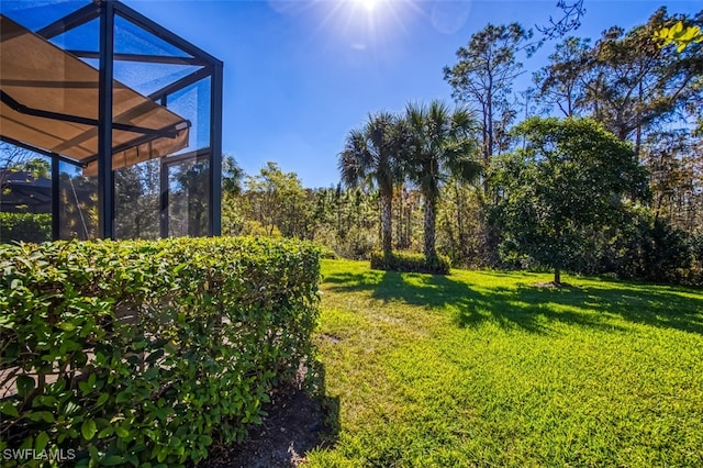 view of yard featuring glass enclosure