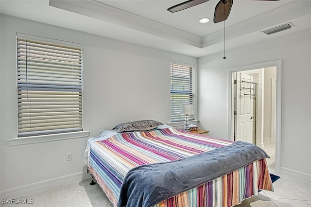 bedroom featuring a tray ceiling, ceiling fan, crown molding, and light tile patterned floors