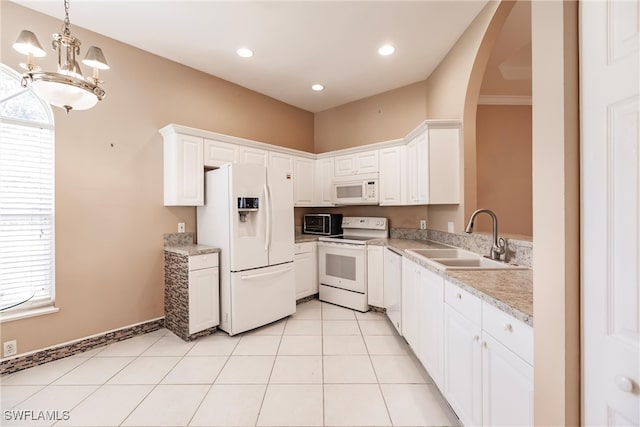 kitchen featuring light tile patterned flooring, sink, white appliances, white cabinetry, and a notable chandelier