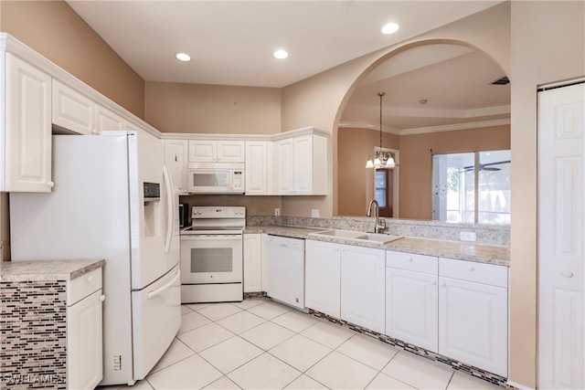 kitchen with sink, a notable chandelier, white cabinets, white appliances, and light tile patterned floors