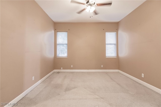 carpeted empty room featuring ceiling fan