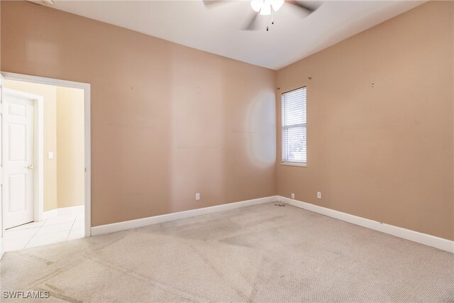 carpeted empty room featuring ceiling fan