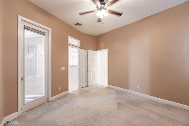 carpeted spare room featuring ceiling fan and plenty of natural light