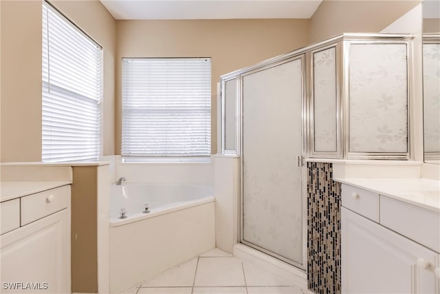 bathroom featuring shower with separate bathtub, tile patterned floors, and vanity