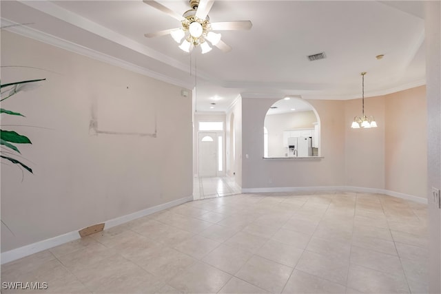 tiled spare room featuring ceiling fan with notable chandelier and ornamental molding