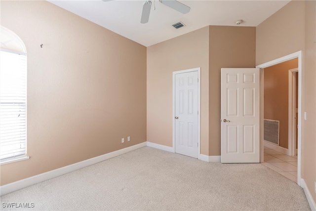 unfurnished bedroom featuring ceiling fan and light colored carpet