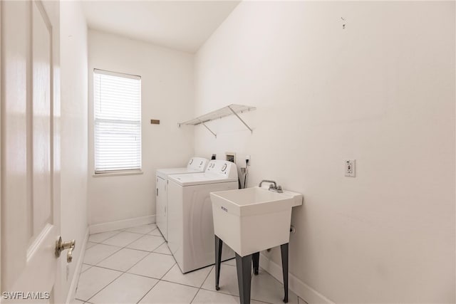 clothes washing area featuring light tile patterned flooring and independent washer and dryer