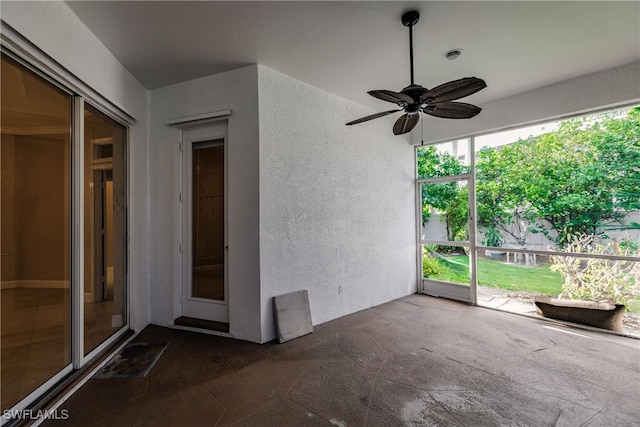 interior space featuring ceiling fan and a patio area