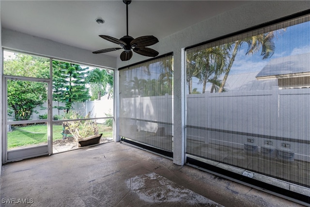 unfurnished sunroom with ceiling fan and plenty of natural light