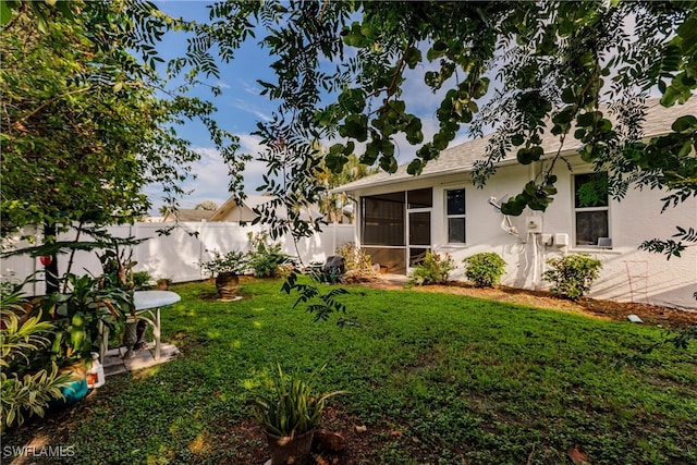 view of yard with a sunroom