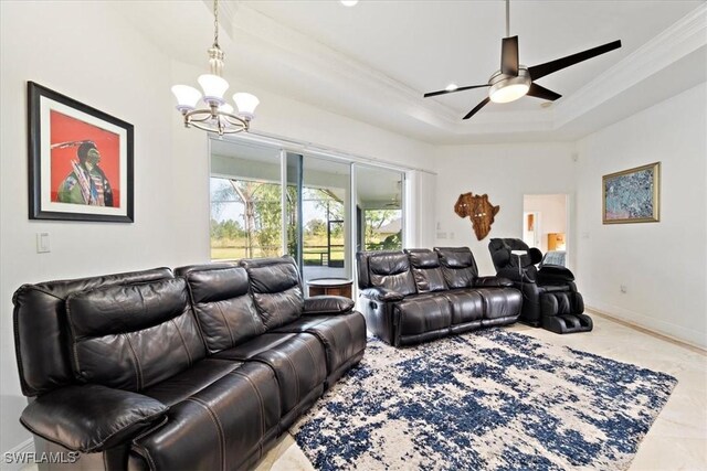 living room with ceiling fan with notable chandelier, ornamental molding, and a raised ceiling