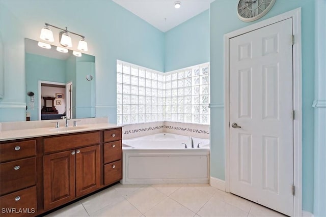 bathroom featuring vanity, tile patterned flooring, and a bathtub