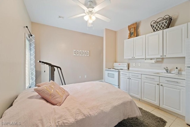 tiled bedroom featuring ceiling fan and sink