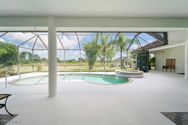 view of swimming pool with an in ground hot tub, ceiling fan, a lanai, and a patio area