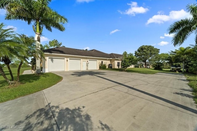 view of front of house with a garage and a front yard