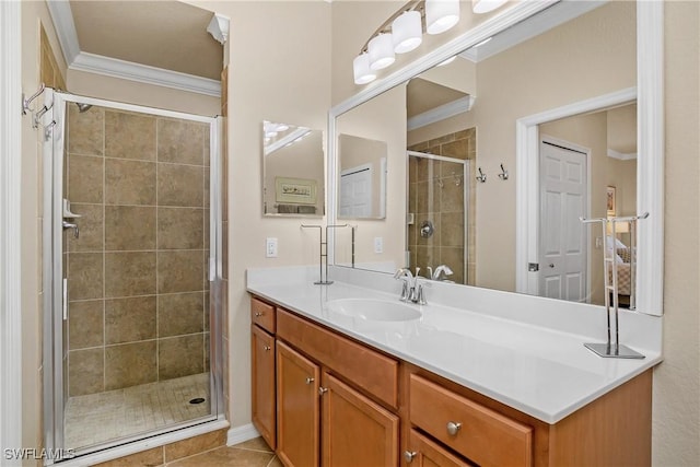 bathroom featuring tile patterned flooring, ornamental molding, vanity, and a shower with shower door