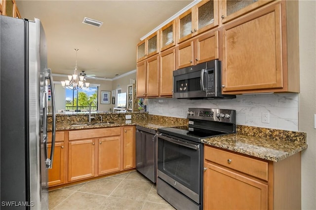 kitchen featuring ornamental molding, stainless steel appliances, sink, dark stone countertops, and light tile patterned flooring