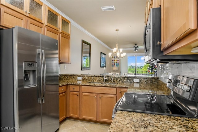 kitchen featuring dark stone countertops, appliances with stainless steel finishes, light tile patterned floors, ceiling fan with notable chandelier, and ornamental molding