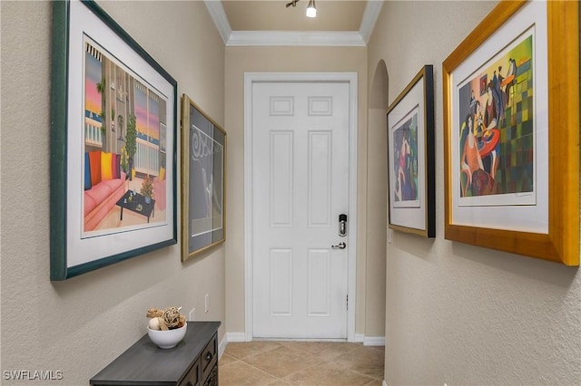 doorway to outside with light tile patterned floors and crown molding