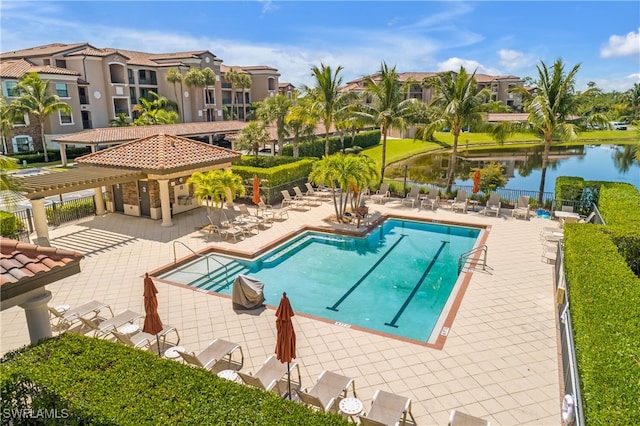 view of pool featuring a pergola, a patio area, and a water view