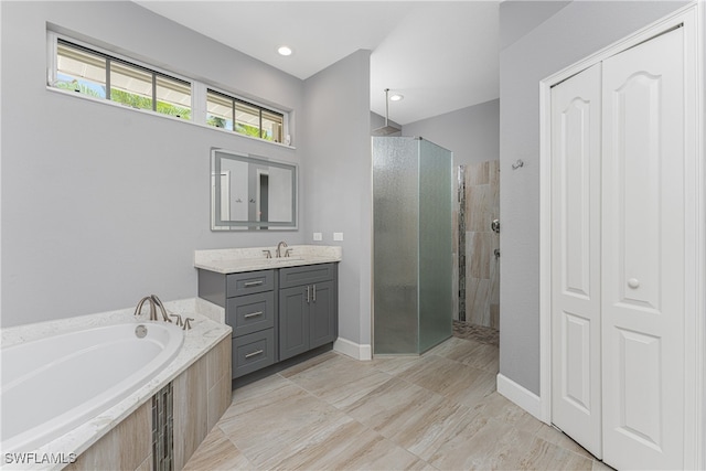 bathroom with independent shower and bath and vanity