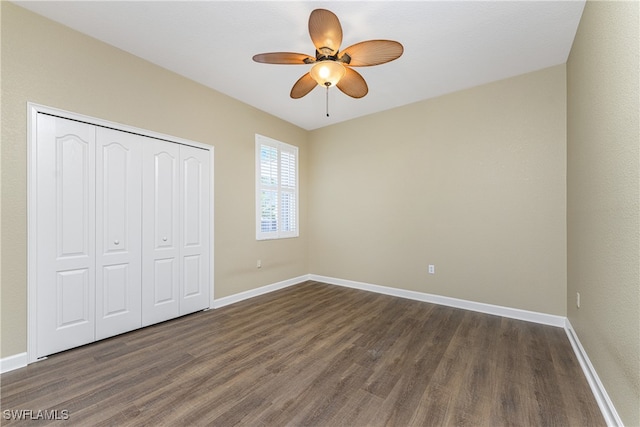 unfurnished bedroom featuring ceiling fan, dark wood-type flooring, and a closet