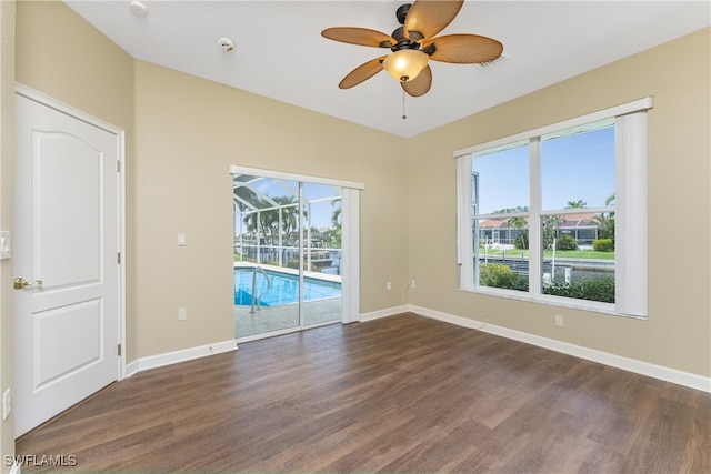 spare room with ceiling fan and dark hardwood / wood-style flooring