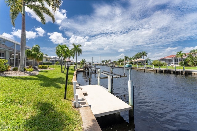 dock area with a yard and a water view