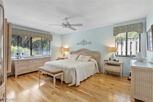 bedroom with light wood-type flooring and ceiling fan