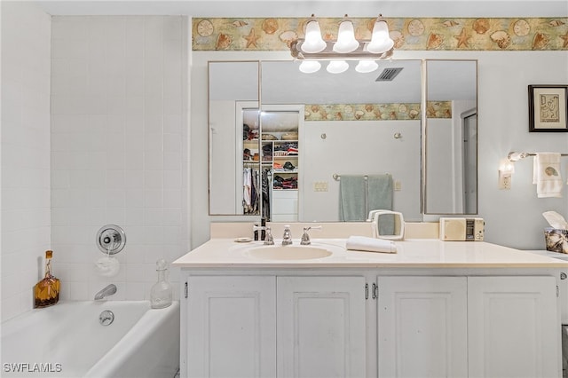 bathroom featuring vanity and independent shower and bath