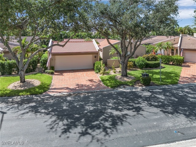 view of front of home with a garage and a front yard