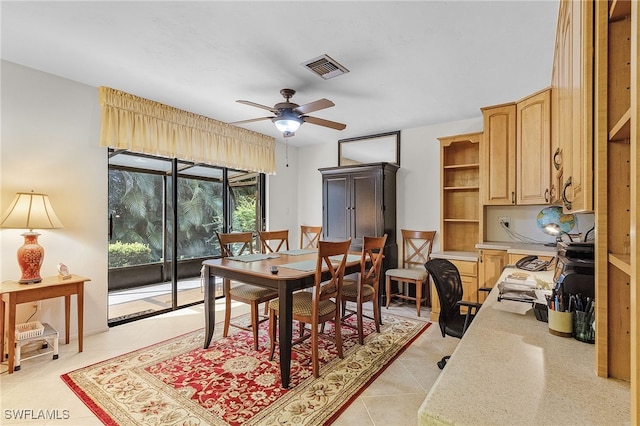 tiled dining area featuring ceiling fan