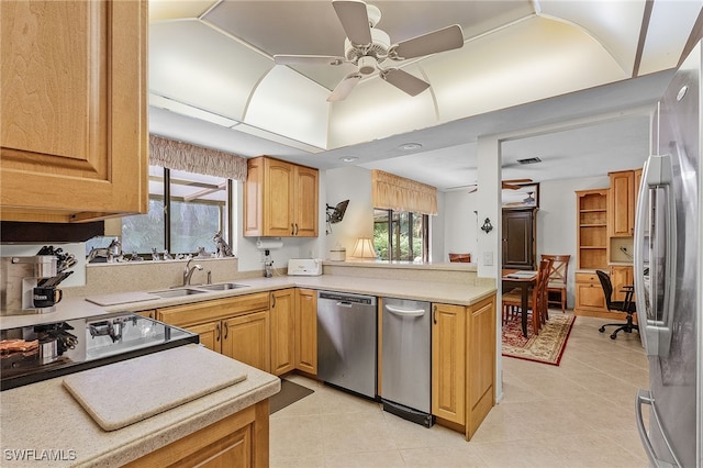 kitchen featuring ceiling fan, light tile patterned floors, stainless steel appliances, and sink