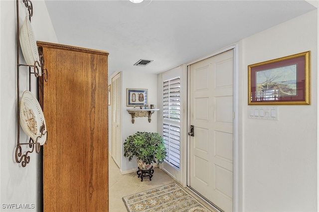 foyer entrance with light tile patterned flooring