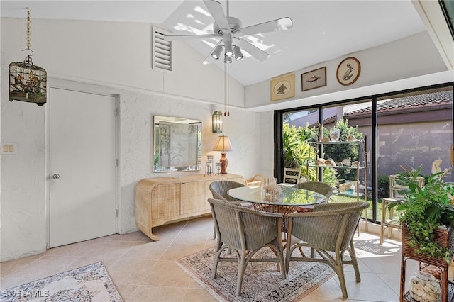 tiled dining area featuring high vaulted ceiling and ceiling fan