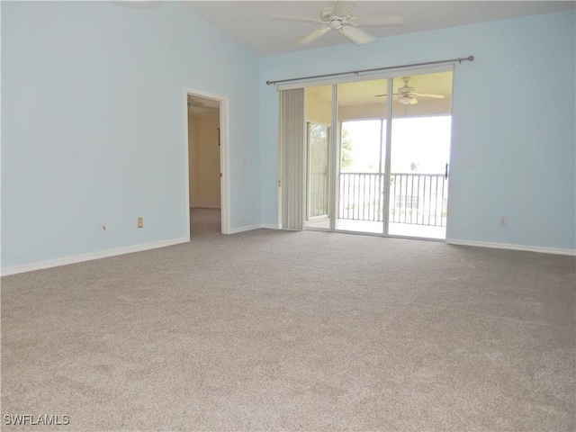 empty room with vaulted ceiling, ceiling fan, and carpet