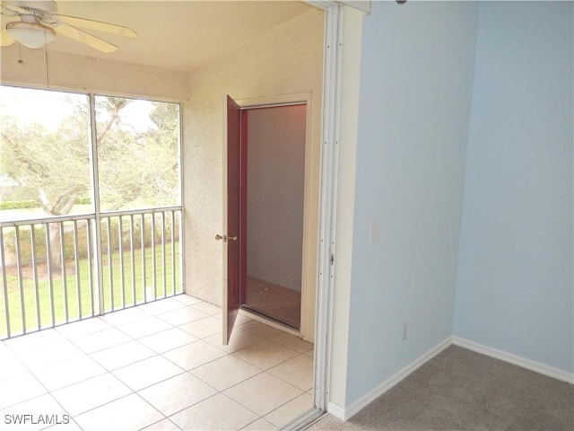 unfurnished sunroom with ceiling fan