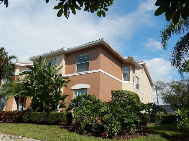 14521 Daffodil Dr Unit 1508, Fort Myers, FL 33919 - view of property exterior with stucco siding
